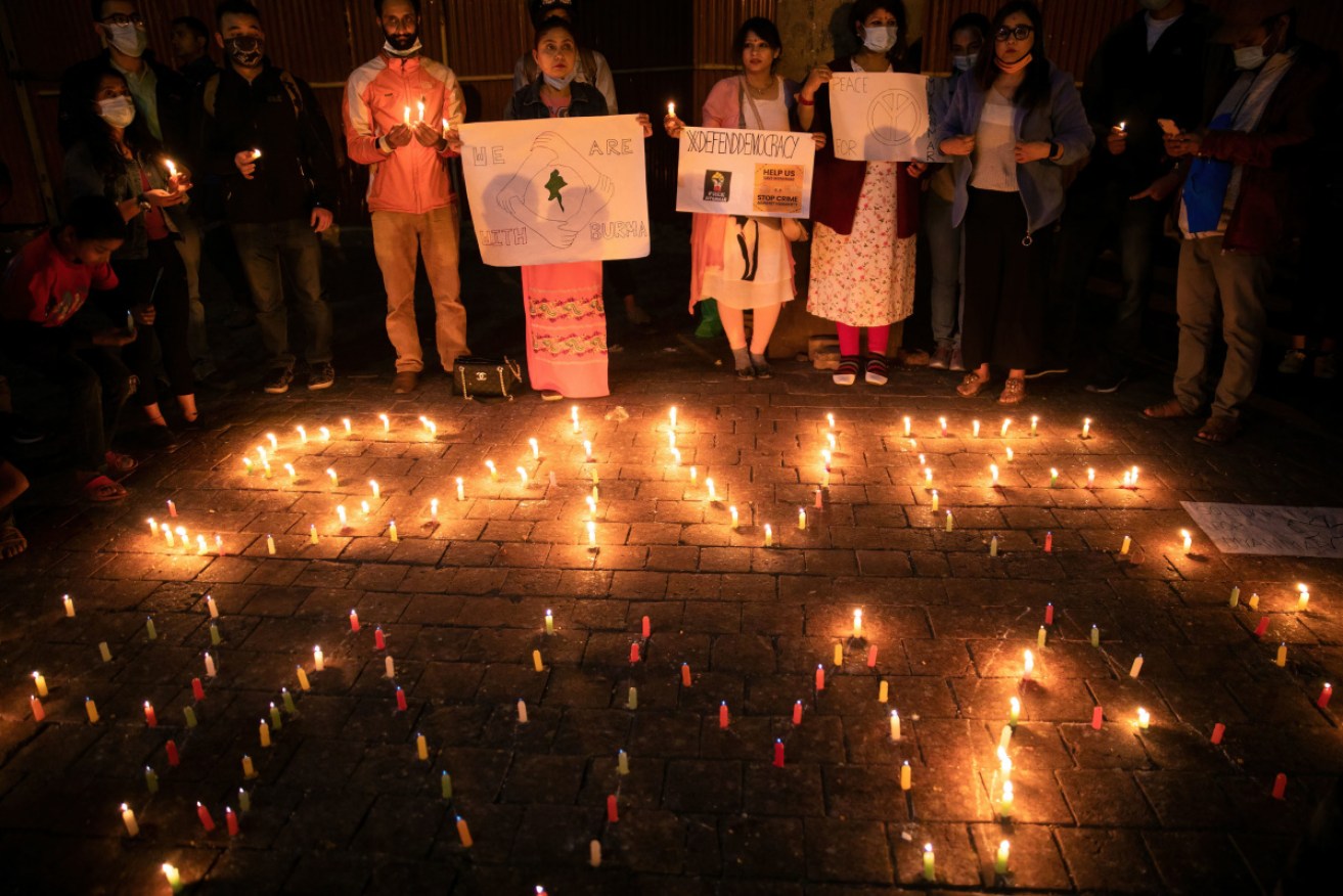 Protesters attend a candlelight vigil for those who died in protests during Myanmar's military coup.