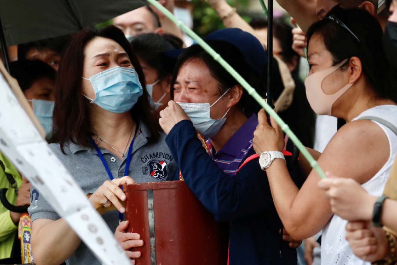 Relatives of the dead and missing dissolve in tears as the hunt for bodies continues. Photo: EPA