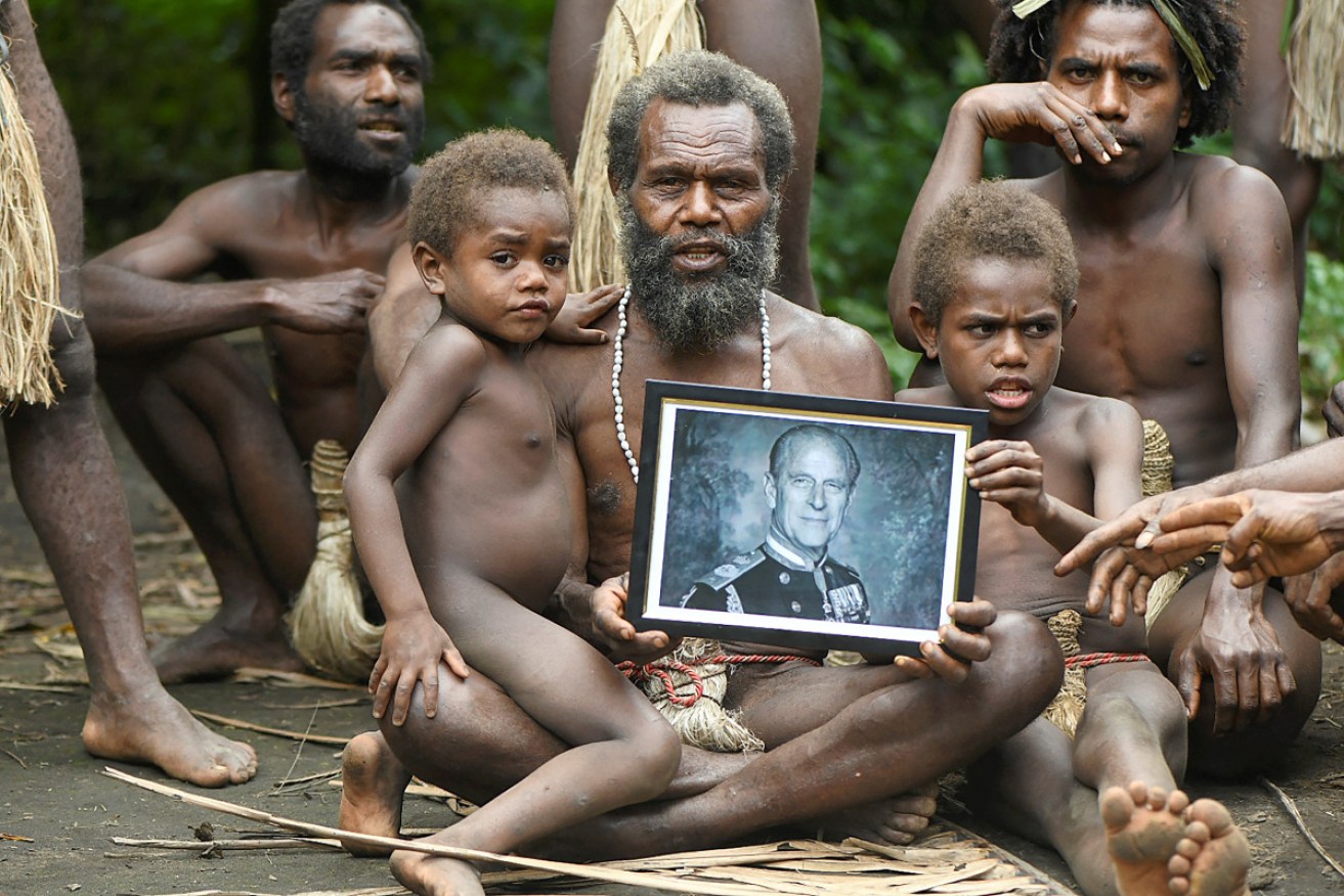 Yakel village chief Albi, and members of his family, holds a portrait of Prince Philip.