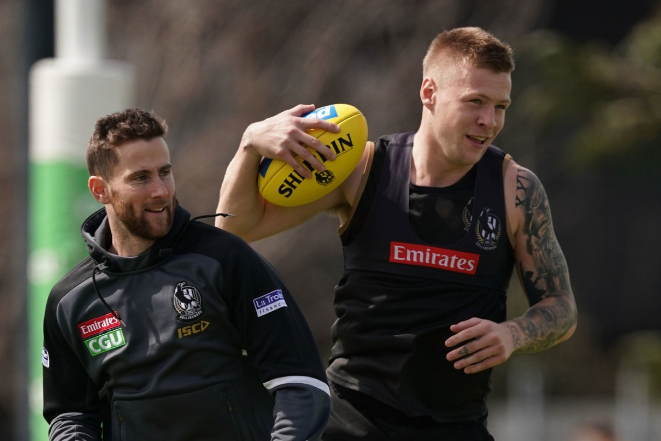 Jeremy Howe and Jordan DeGoey, pictured in 2019, used their phones during the Magpies’ match against the Eagles.