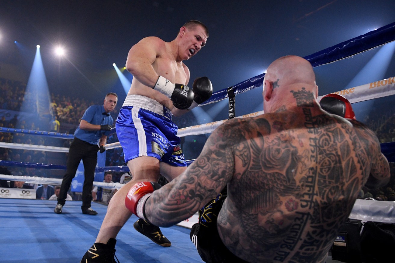 Paul Gallen knocks Lucas Browne to the canvas at the Wollongong Entertainment Centre on Wednesday night.