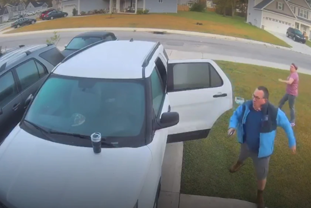 Mr Wade rushes to help his wife as the bobcat attacks.