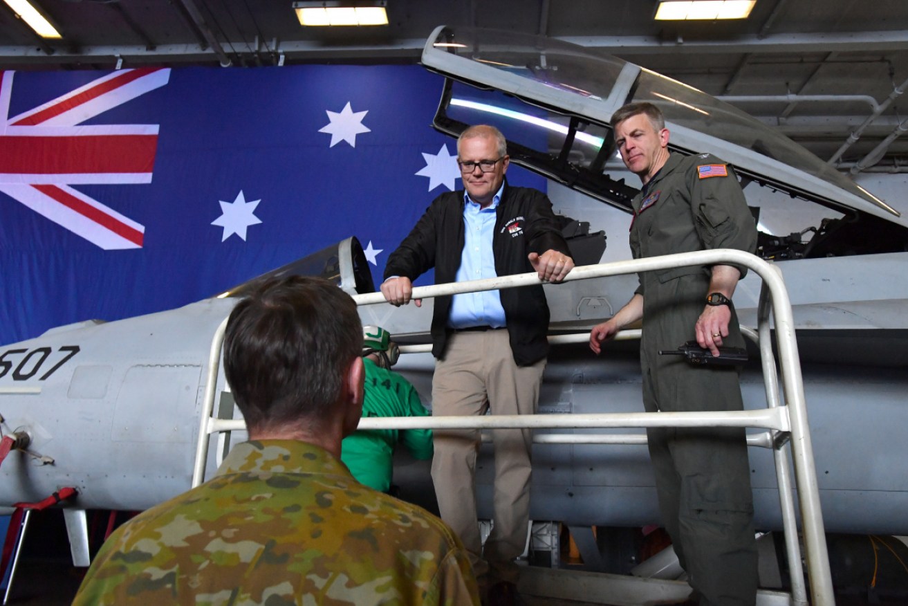 Prime Minister Scott Morrison, seen here in 2019 with the Commanding officer of the USS Ronald Reagan during a joint training exercise, is expected to announce sweeping upgrades of military training bases on a visit to the Northern Territory. 