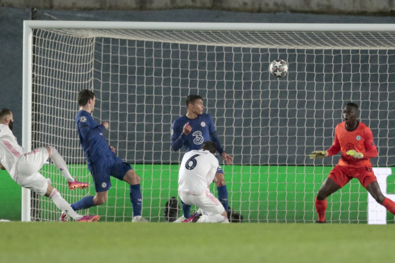 Karim Benzema, left, scores Real Madrid's equaliser.