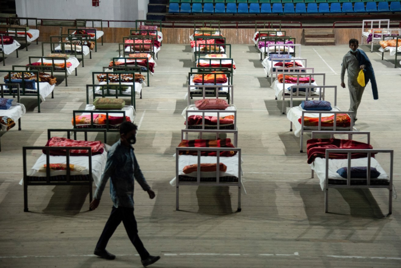 Rows of beds set up for COVID patients at a makeshift hospital in a sports stadium in Srinagar.