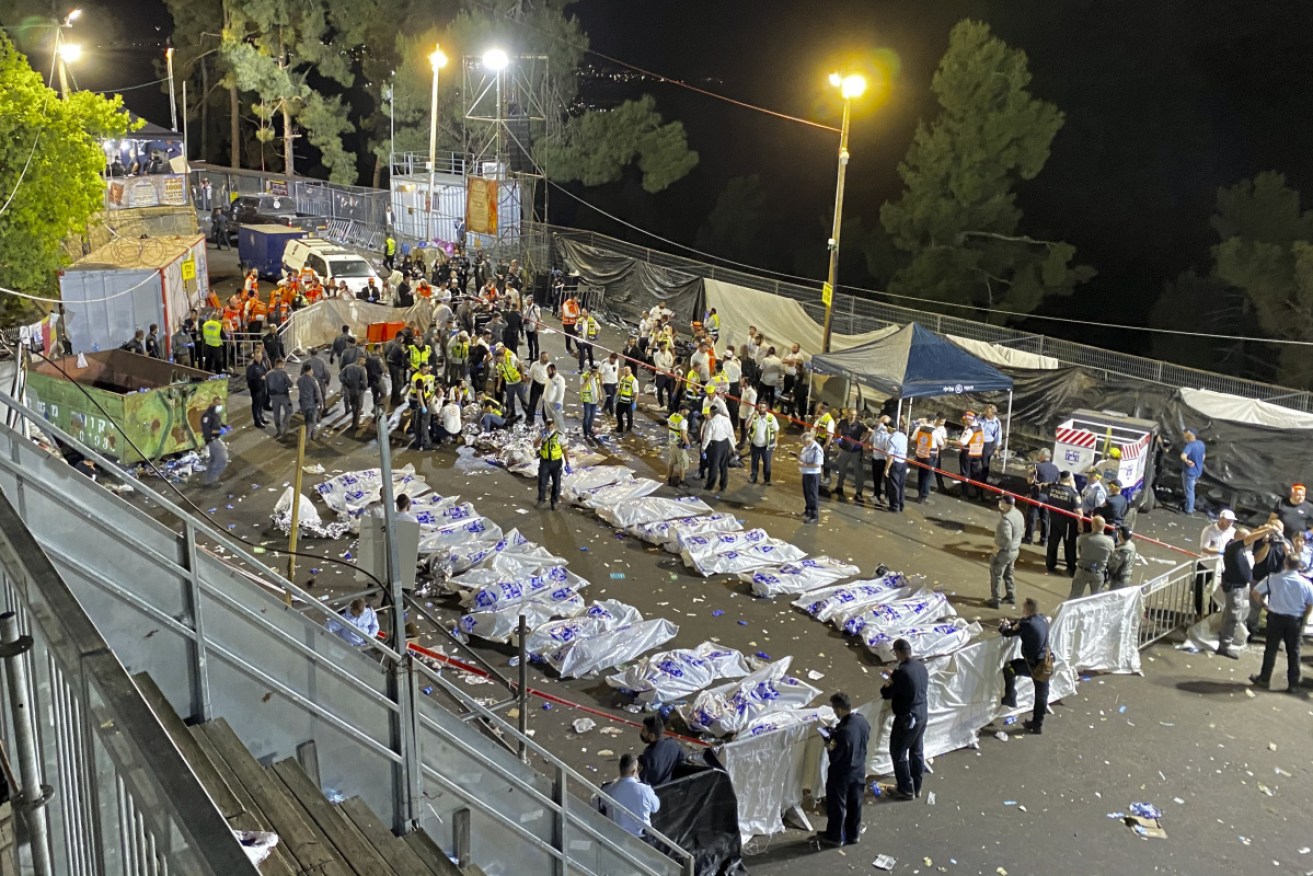 The devastating scene outside the site, with bodies on the ground surrounded by rescuers.