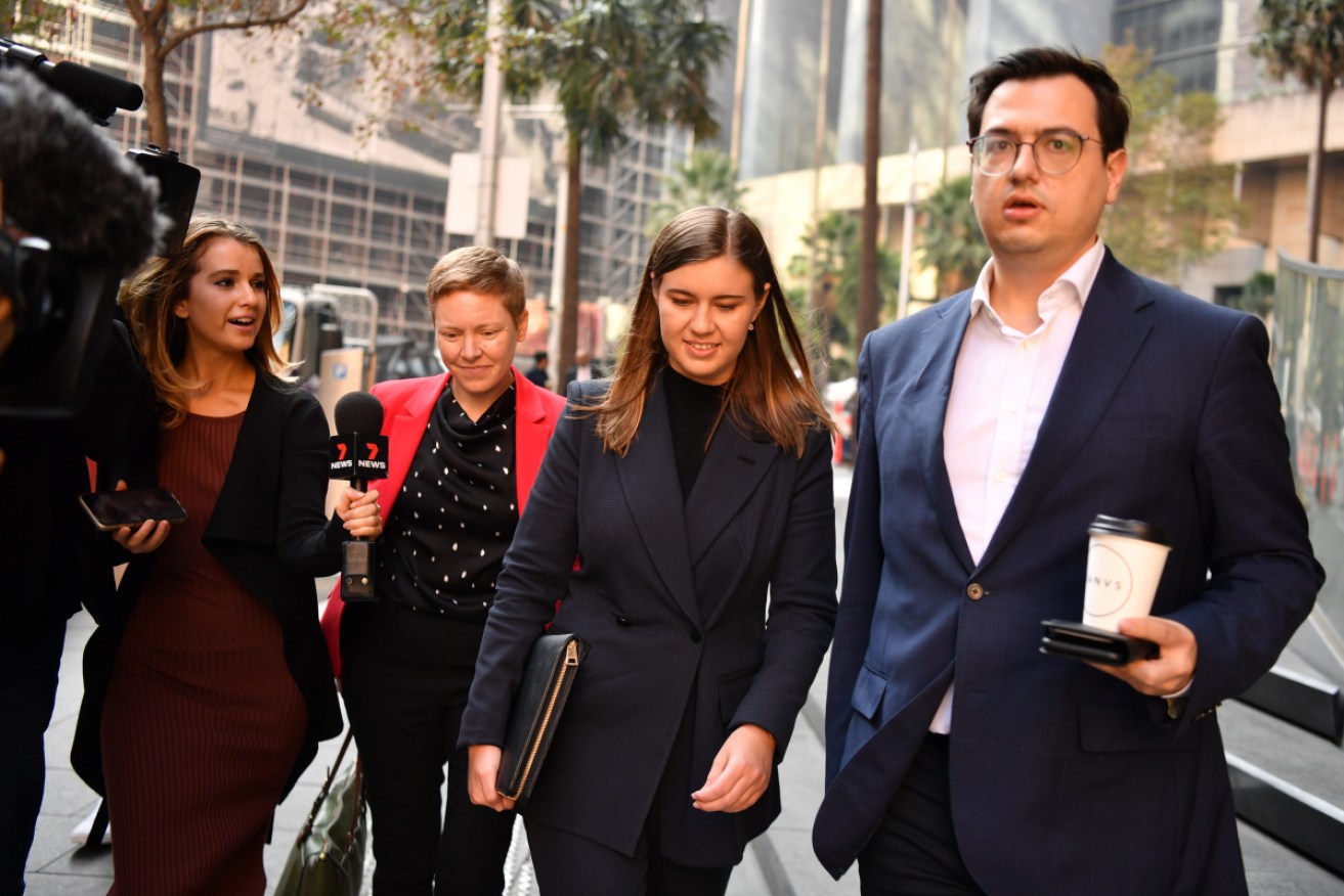 Brittany Higgins (centre) leaves Anthony Albanese's Sydney offices on Friday morning.