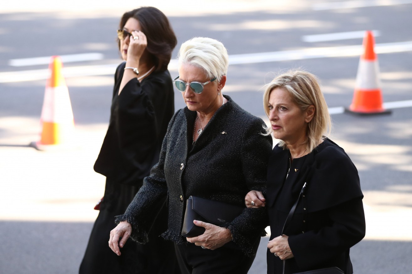 Kerryn Phelps (centre) and wife Jackie Stricker-Phelps at the funeral of designer Carla Zampatti in April.