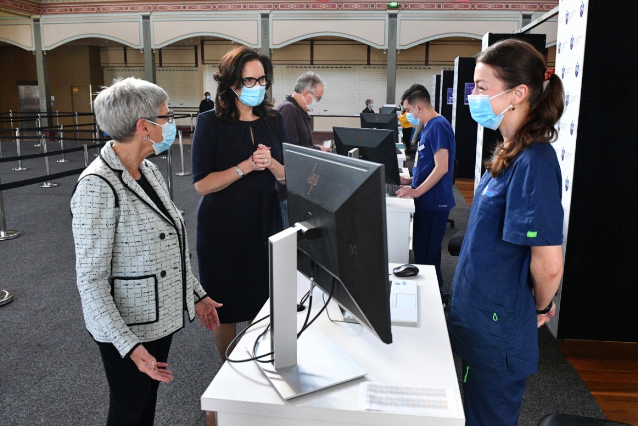 Victorian Governor Linda Dessau (left) received her COVID-19 vaccination at the hub at Melbourne's Royal Exhibition Building on Saturday.