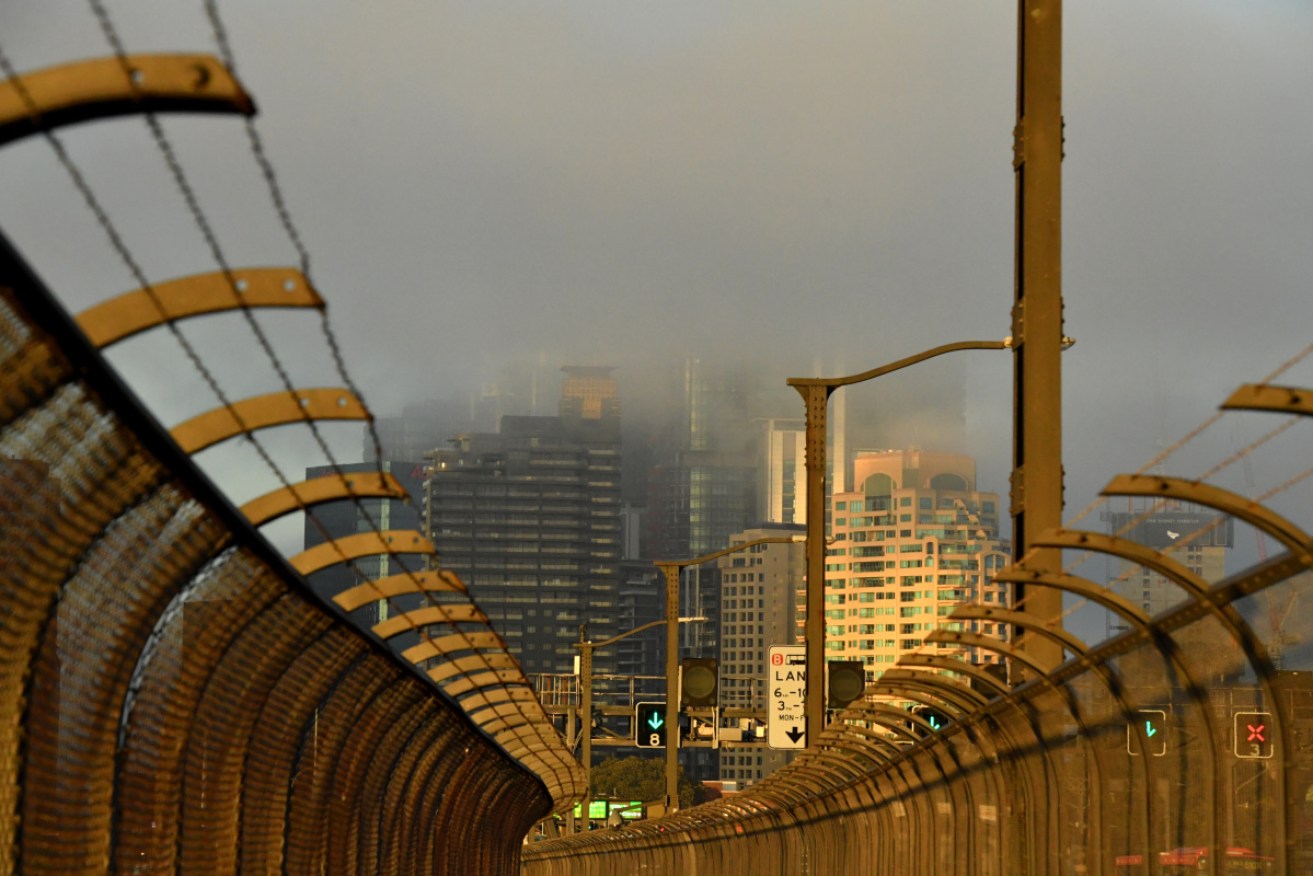 Sydney's skyline was blanketed in a blend of smoke and fog on Monday morning.
