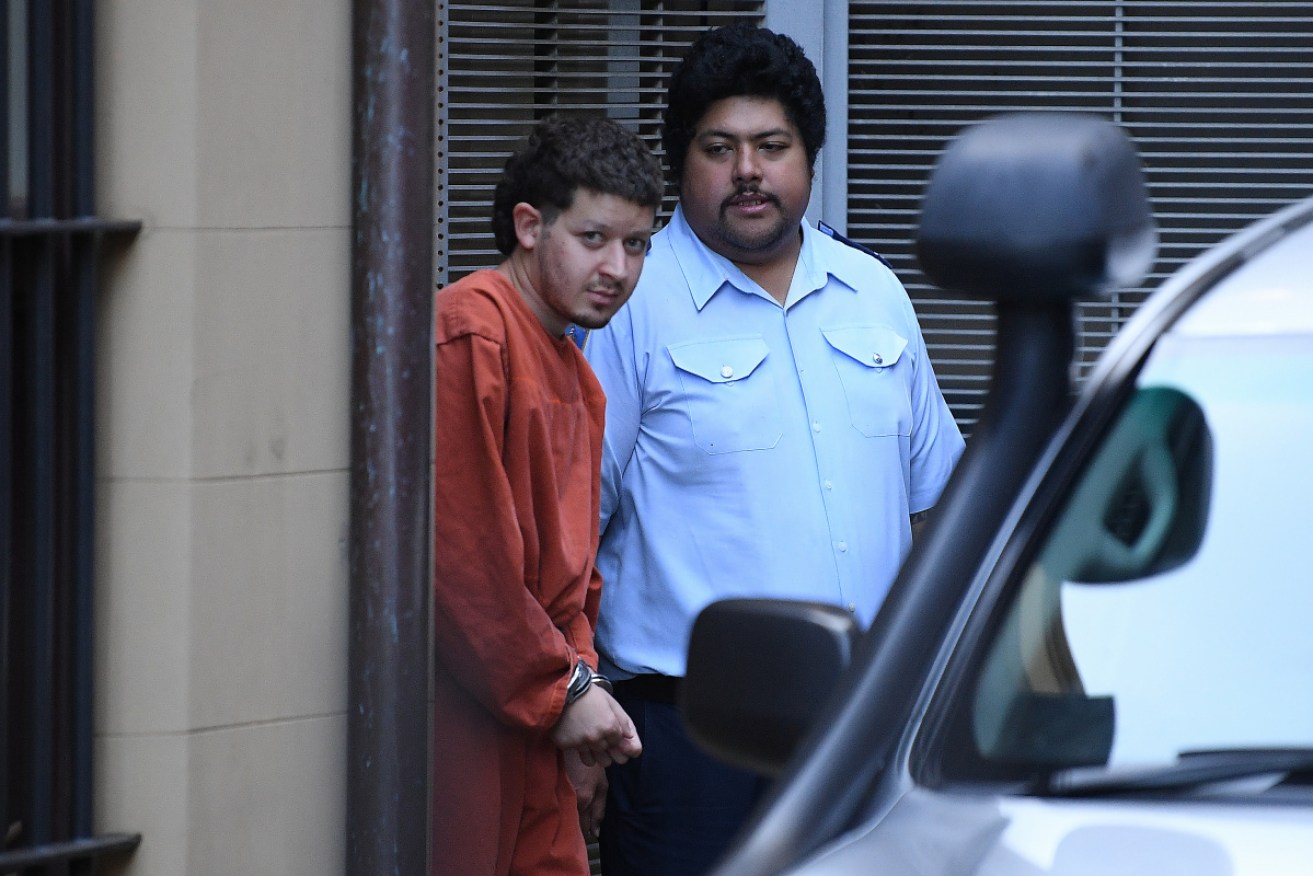 Mert Ney is led to a Corrective Services transport vehicle at the NSW Supreme Court on March 30, 2021.