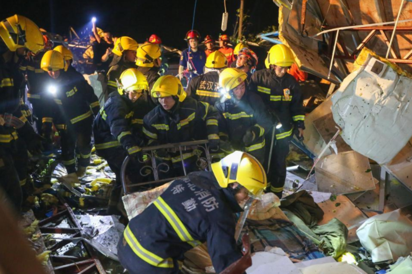 Emergency workers pick through the rubble for survivors of the fierce winds.