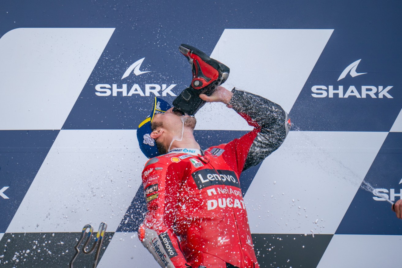 Jack Miller drinks Prosecco out of his boot after his race win in the French Moto GP. Photo: Getty