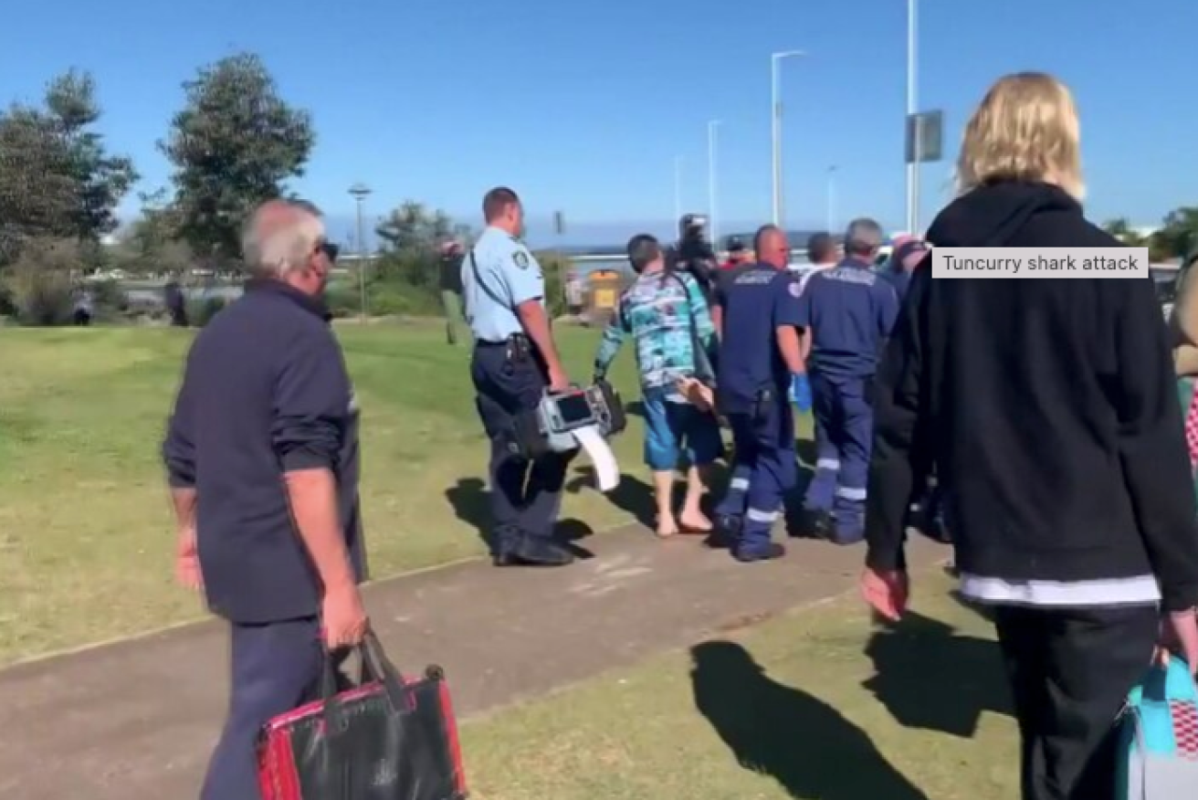 Distressed locals watched as paramedics carried the man to a nearby dog park.