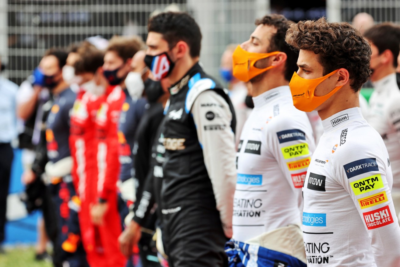 Lando Norris (R) and Daniel Ricciardo line up with the formula one field. 