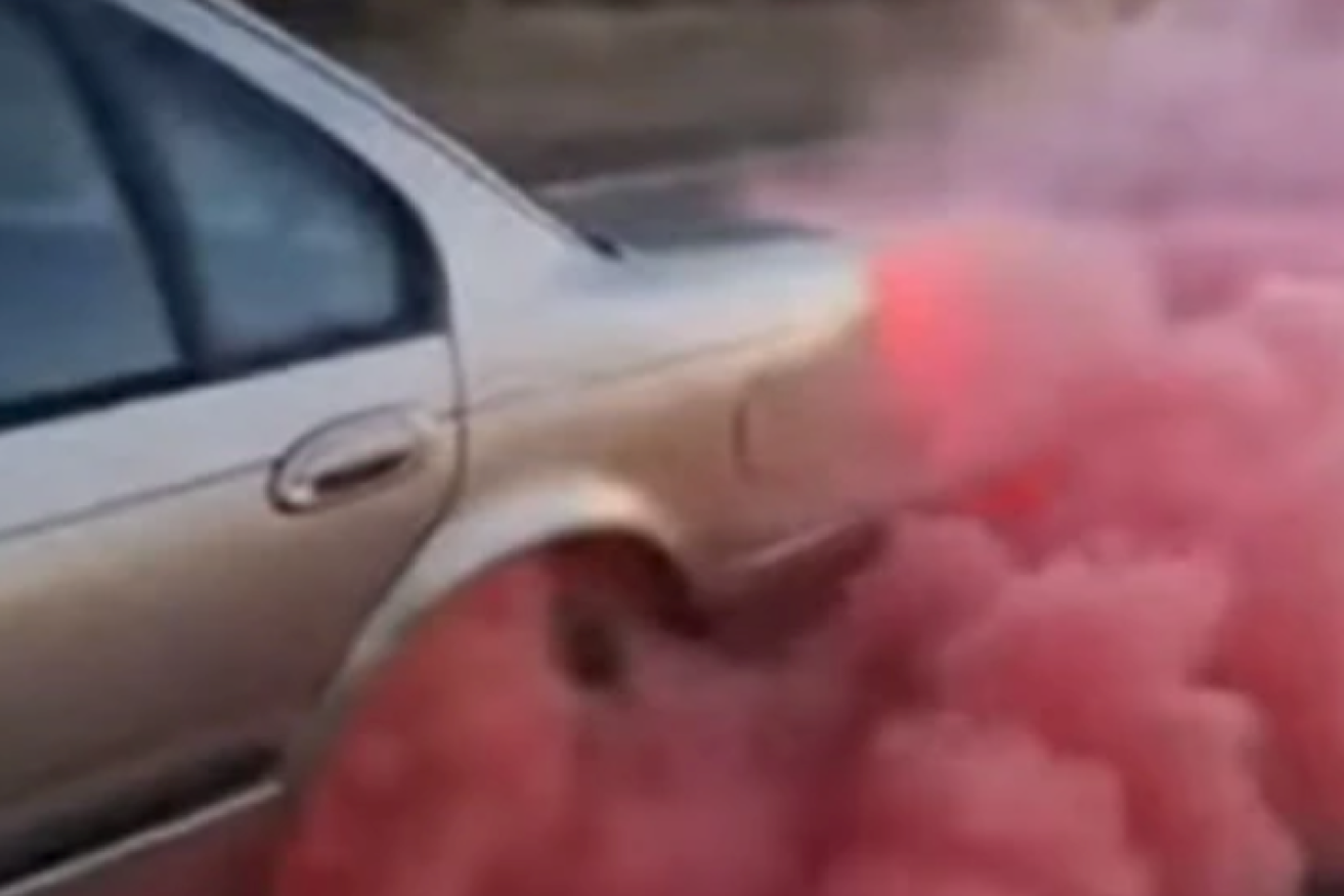 One of two cars involved in the incident billowed pink smoke from its back wheels.