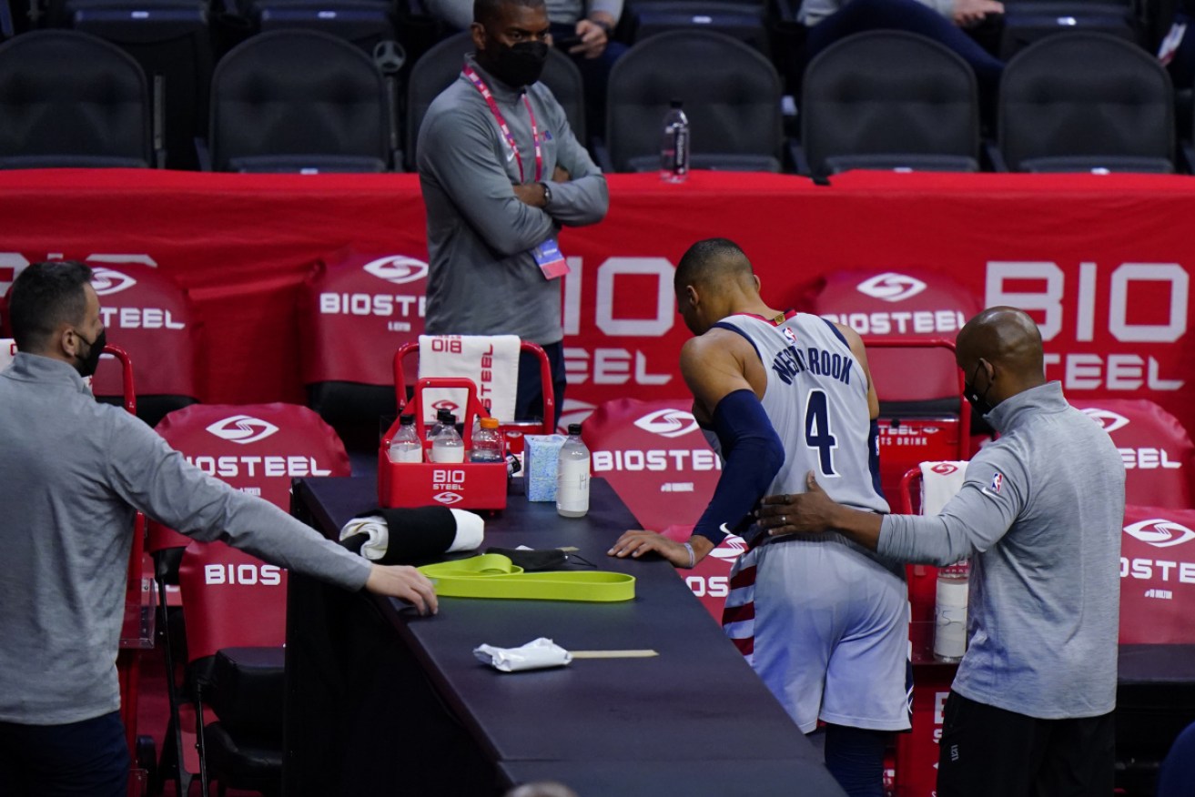 Russell Westbrook is helped off the court, just before a 'fan' adds insult to injury.