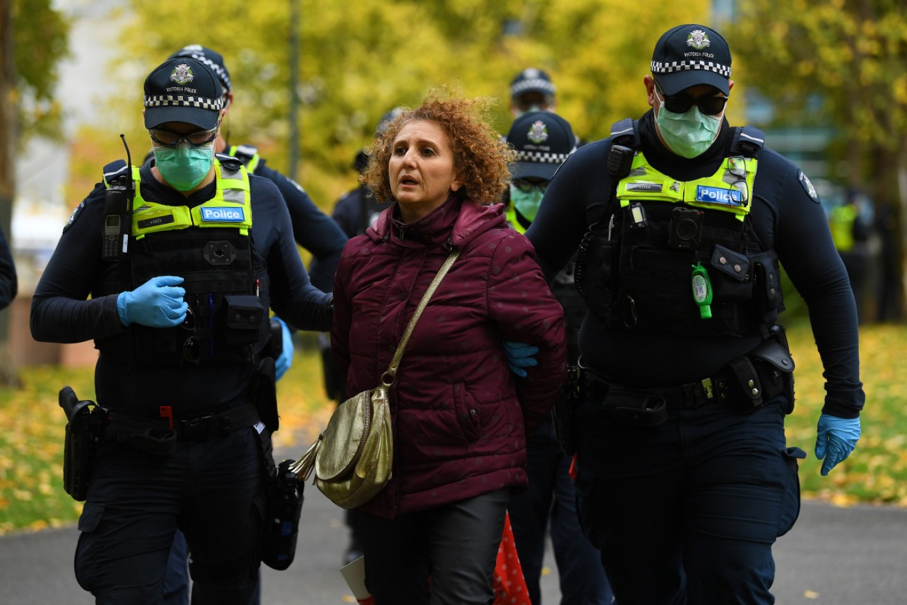 At least three people have been arrested at a march in Melbourne protesting the tough restrictions. 