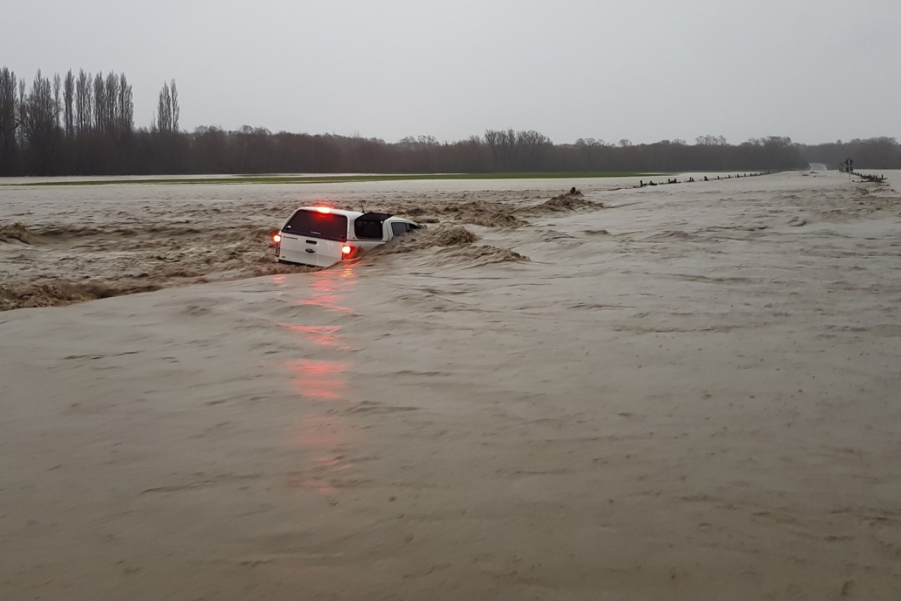 An abandoned car in flooded waters in Ashburton Forks near Christchurch on Sunday.