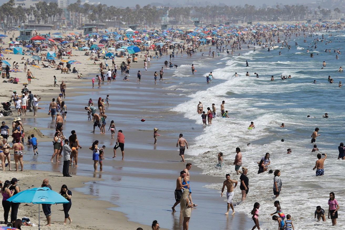 Visitors crowd the beach in Santa Monica, California. 