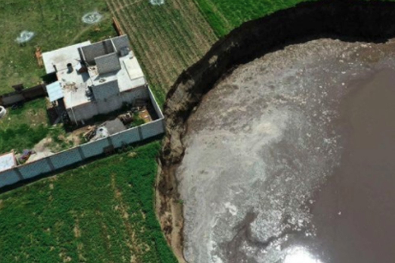 The ever-widening sinkhole is creeping rapidly towards the Sanchez's former home.