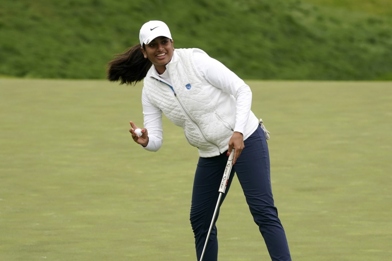 Teenage sensation Megha Ganne, 17, waves after making a putt at the US Women's Open.