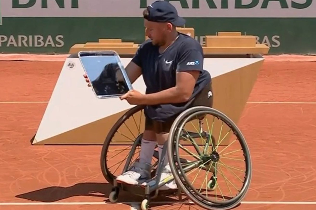 Dylan Alcott celebrates his third singles title at Roland Garros on Monday night.