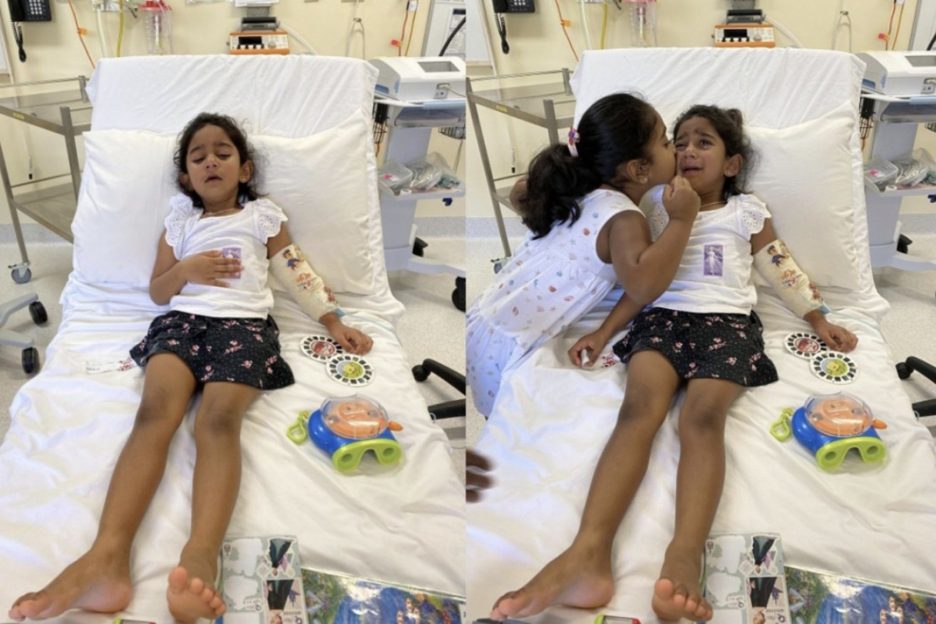 Three-year-old Tharnicaa with sister Kopika before she left Christmas Island. She is now in hospital in Perth.