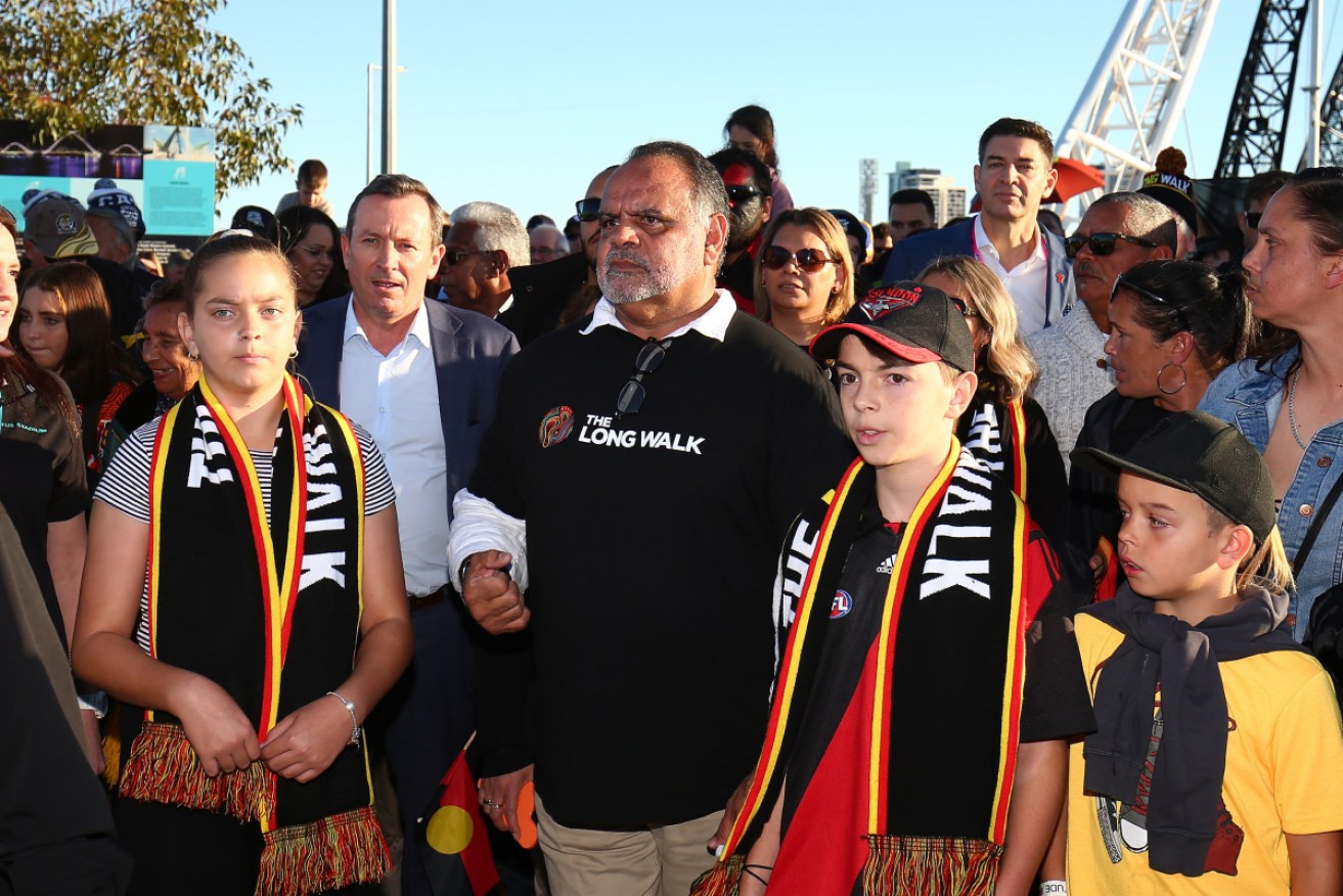 AFL great Michael Long (centre) at The Long Walk in Perth, is recognised in the Queen's Birthday honours.