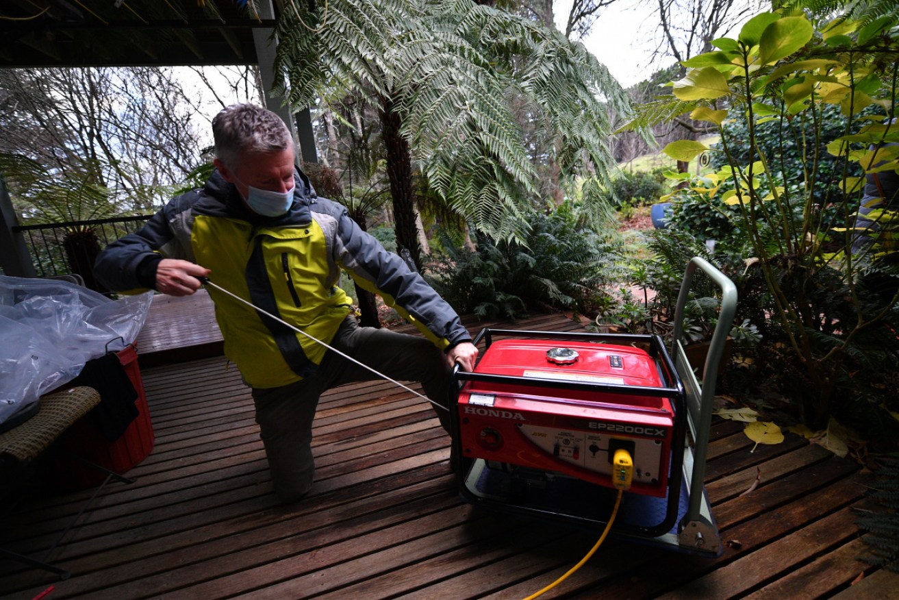 Mark Fergus pulls his generator into life. A week on from the storm, some 9000 properties in the Ranges were still without power. 