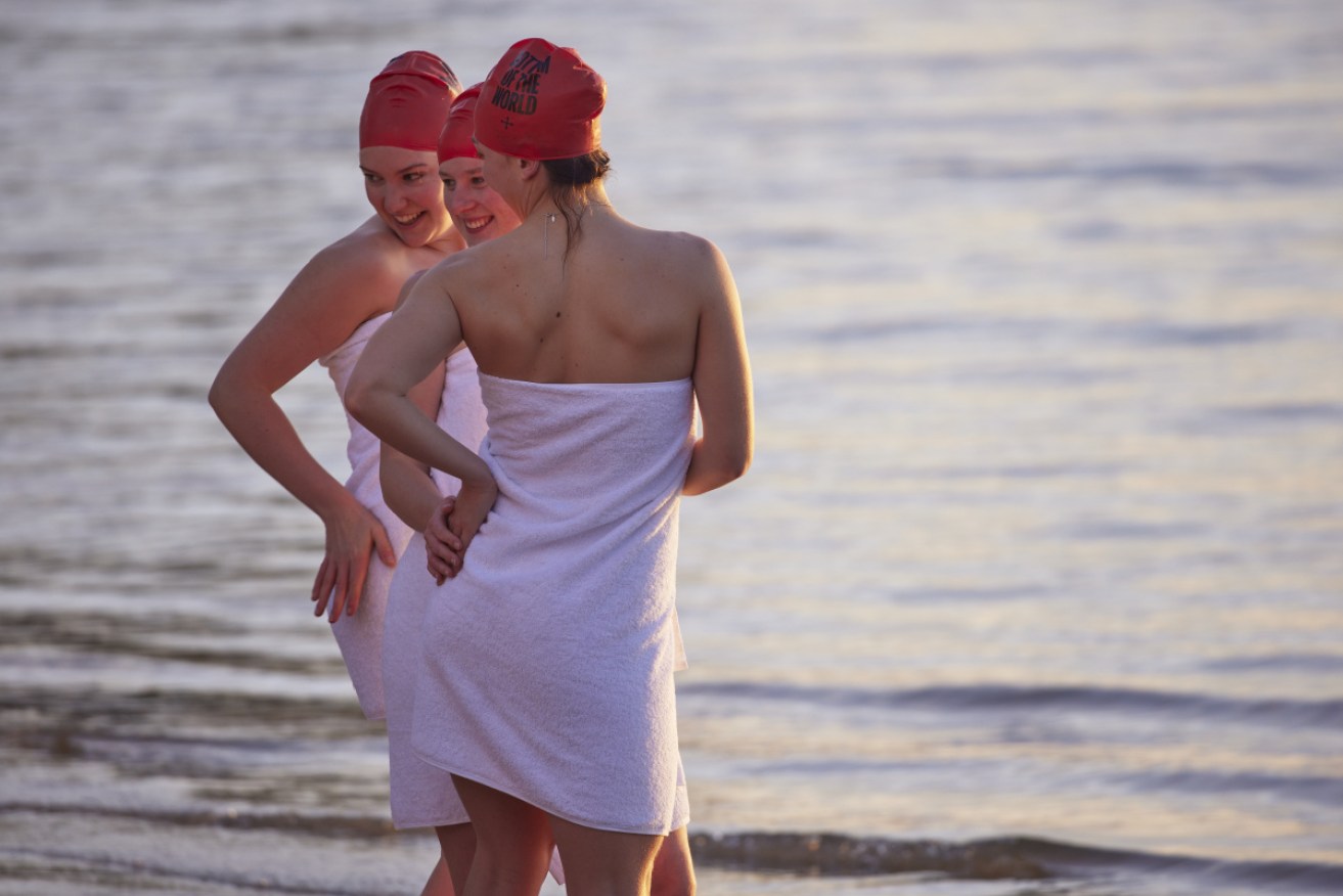 Swimmers pose after their early morning swim at Hobart's Sandy Bay.