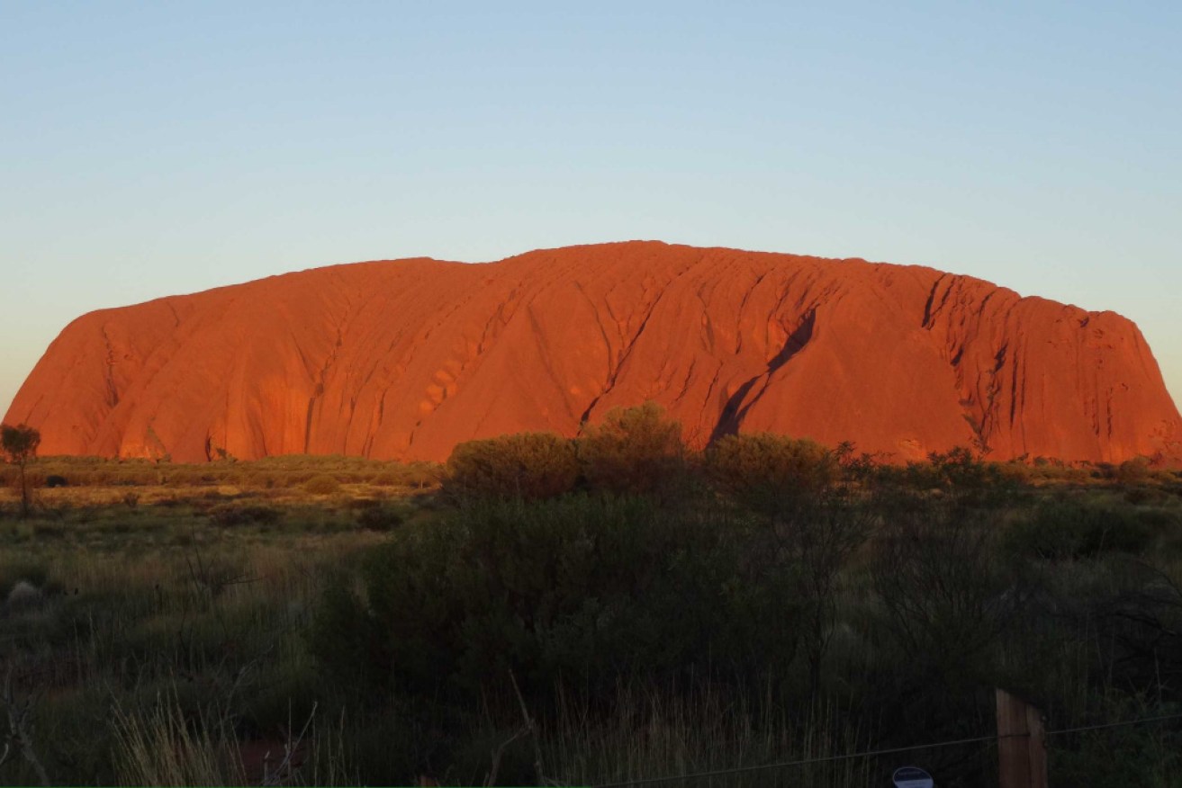 Police say the group was travelling east on the Lasseter Highway, which goes to Uluru, when their vehicle rolled.