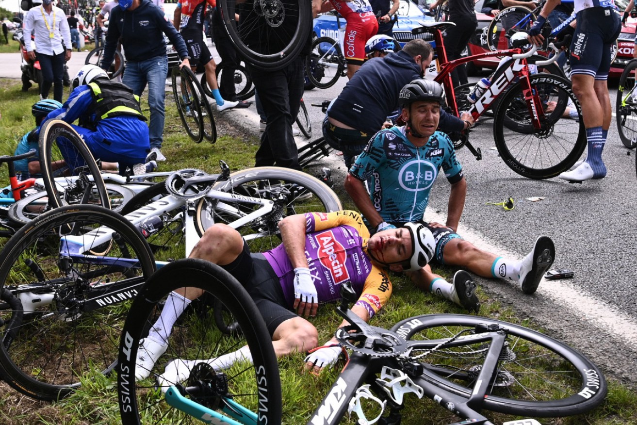 Bryan Coquard of France (R) and a Team Alpecin Fenix' rider lie on the ground after crashing.