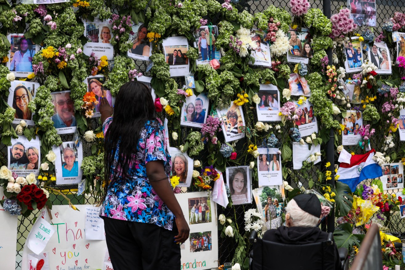 Family members hold a vigil for the more than 140 people still missing in the rubble of the building.