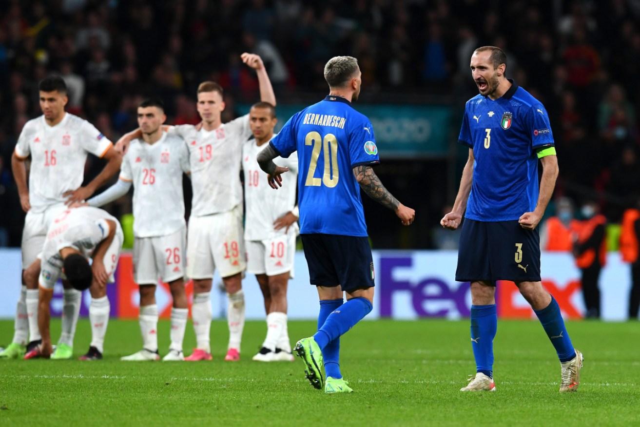 Giorgio Chiellini of Italy celebrates with Federico Bernardeschi after he scores his side's fourth penalty in the penalty shoot-out against Spain.