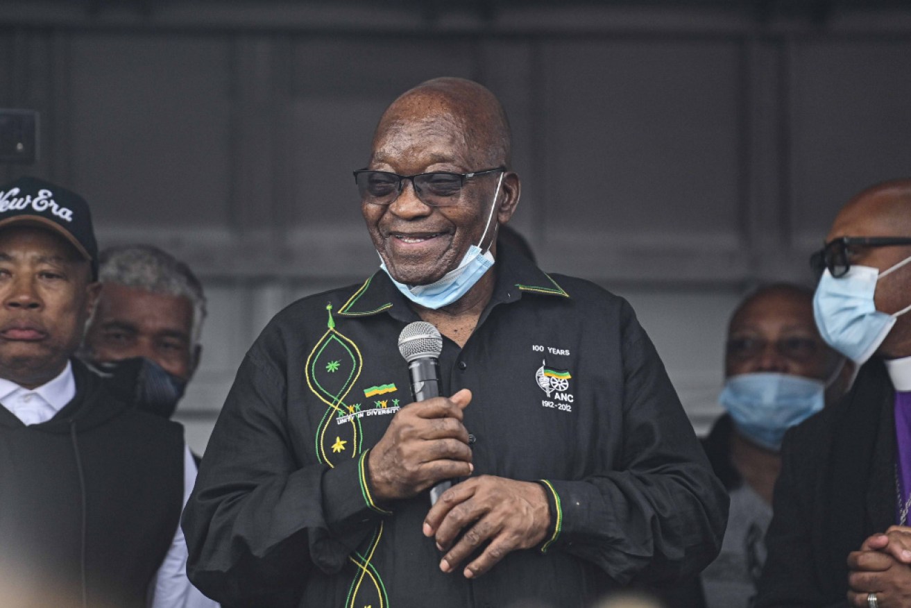Jacob Zuma addresses supporters outside his home on Sunday. He has since handed himself in to police.