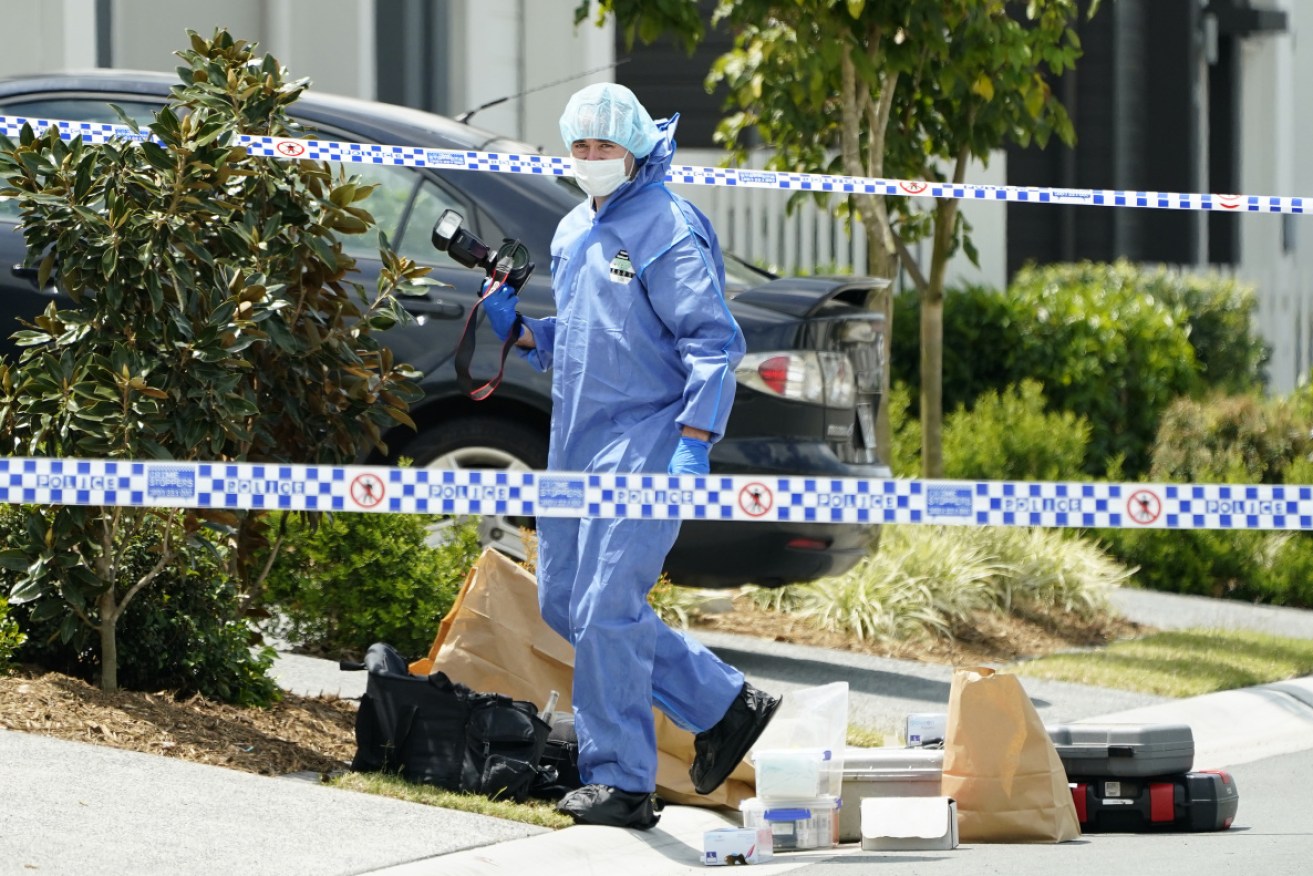 
Forensic officers at the scene of the  Gold Coast killing. 