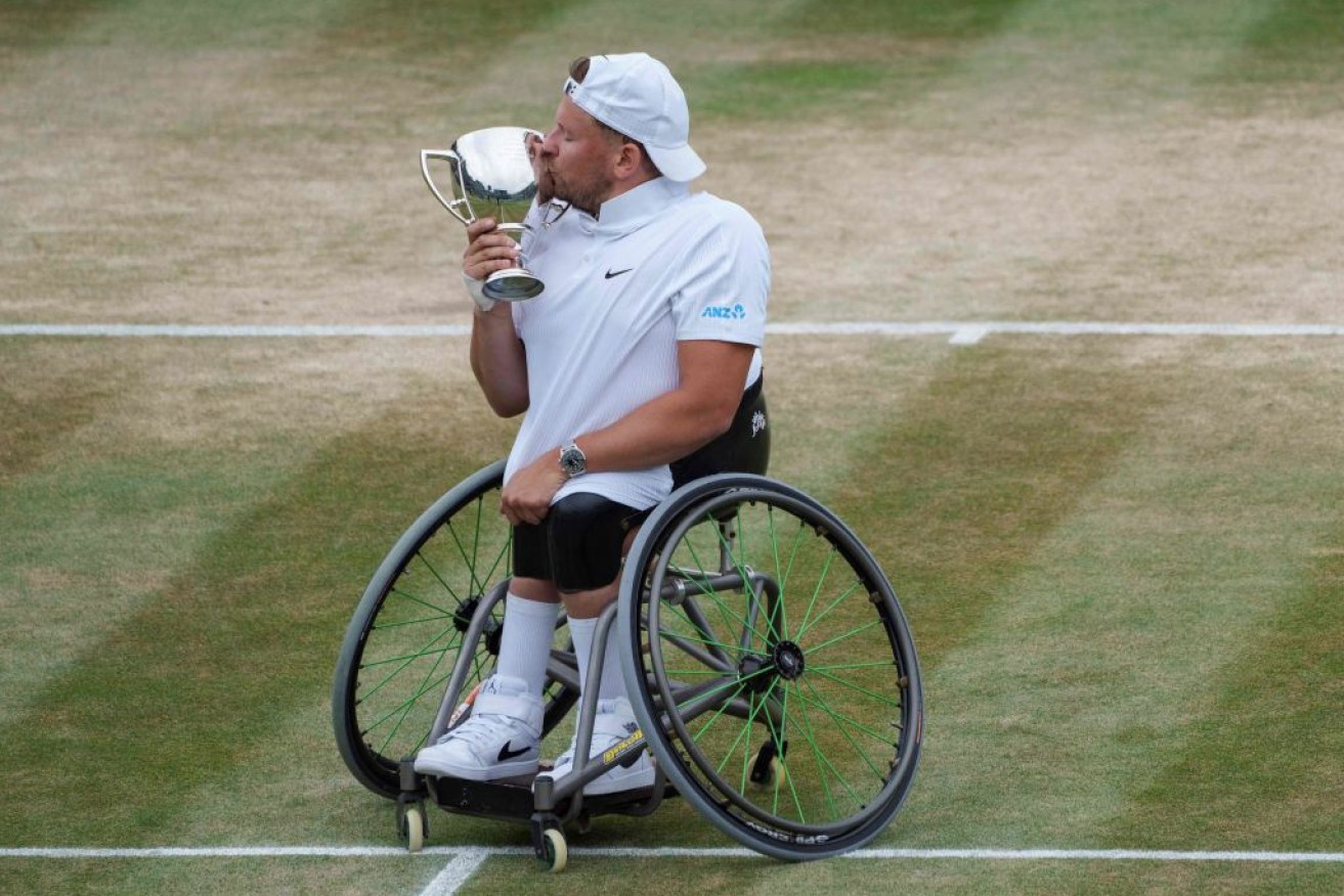 Dylan Alcott kisses the winner's trophy after winning against Netherlands' Sam Schroder in the final of the Quad Wheelchair Singles.