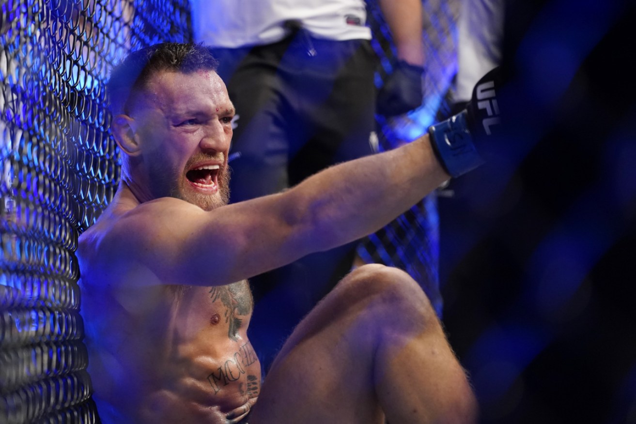 Conor McGregor yells out after breaking his shin in his UFC loss to Dustin Poirier.