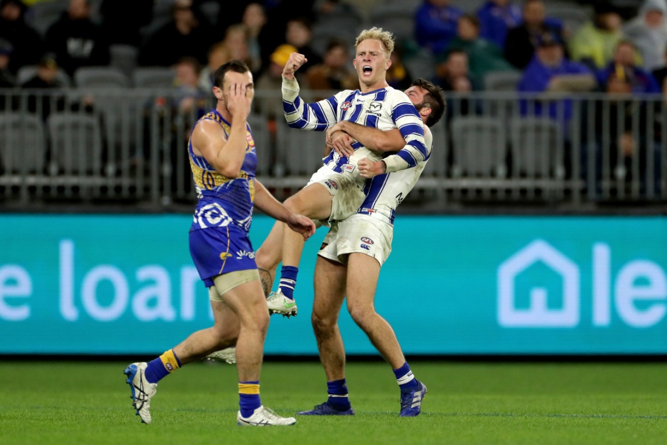 Jaidyn Stephenson of the Kangaroos celebrates with Luke McDonald after kicking a goal during the Round 17 AFL match between the West Coast Eagles and North Melbourne.