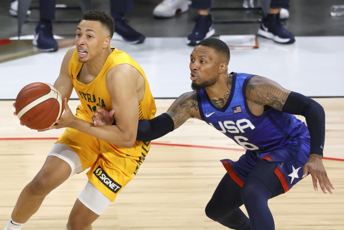 Australia's Dante Exum fends of the US's Damian Lillard as the Boomers down the American team 91-83.