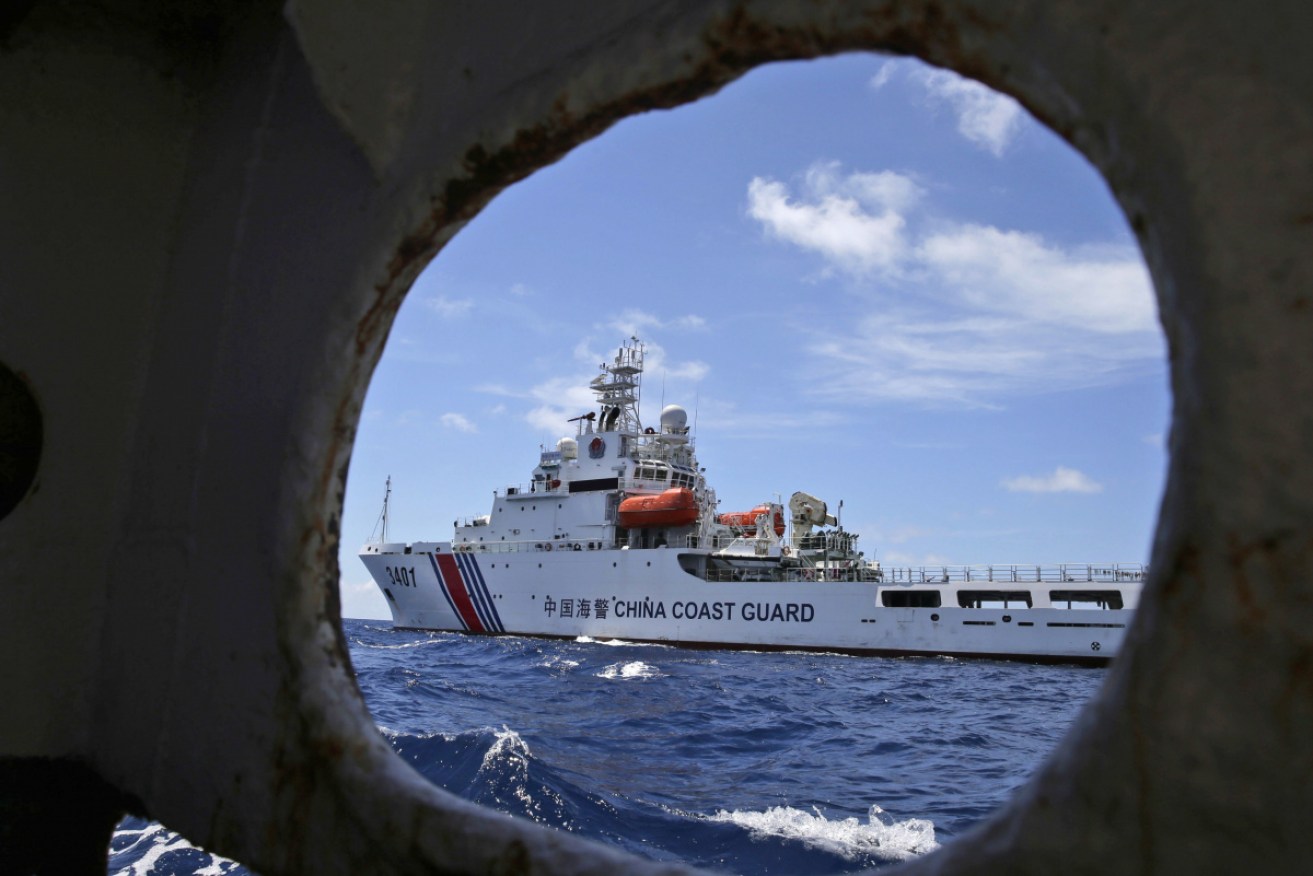A Chinese coast guard ship attempts to block a Philippines vessel in the South China Sea in 2014.