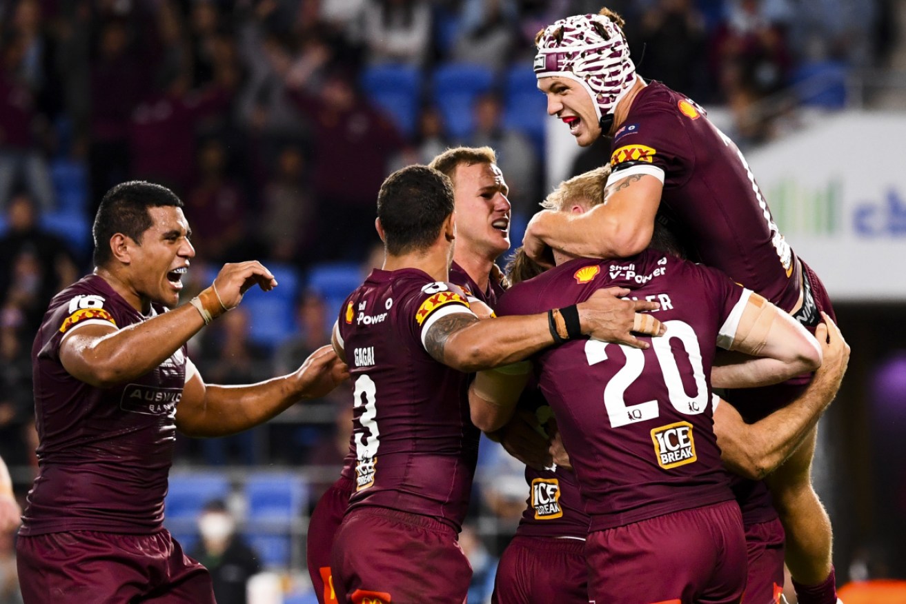 Maroons teammates mob Ben Hunt after a try on the Gold Coast on Wednesday night. 