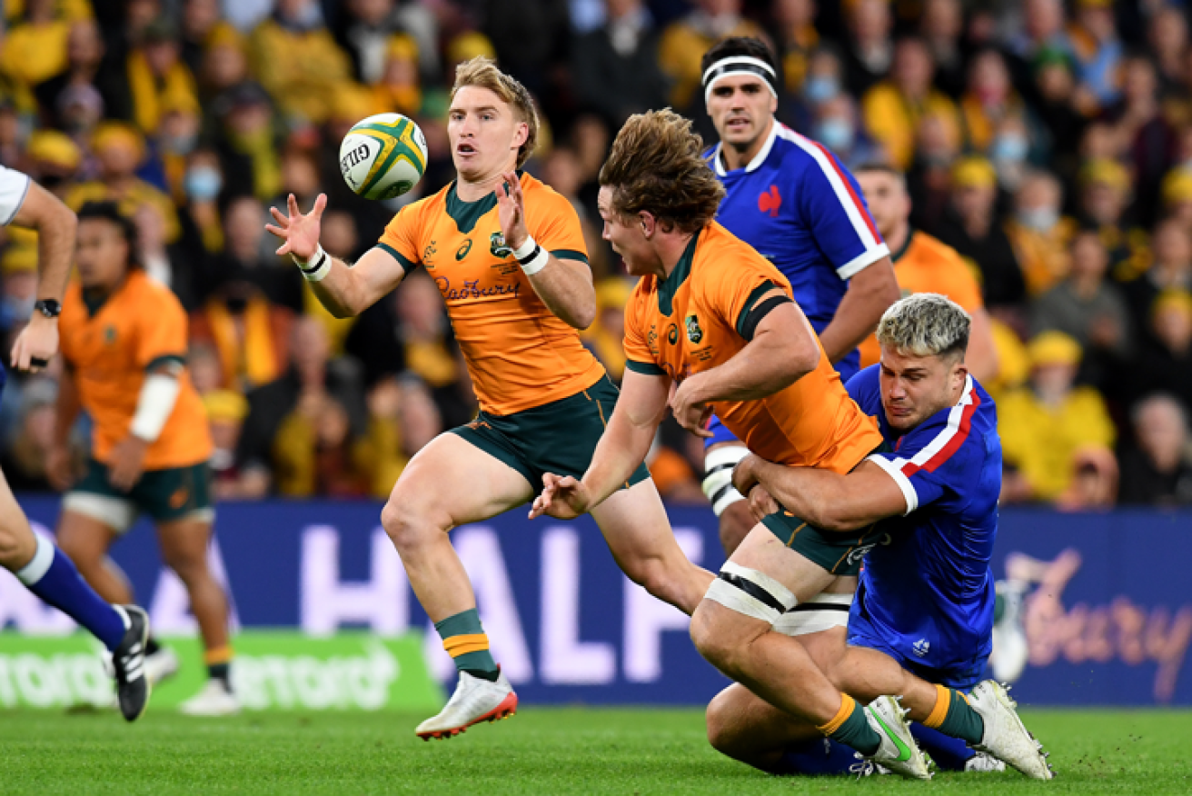 Tate McDermott of the Wallabies receives a pass from Michael Hooper before scoring a try during the third Rugby Union Test between Australia and France.
