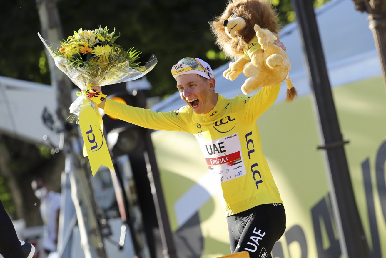 Tadej Pogacar celebrates his Tour de France victory.