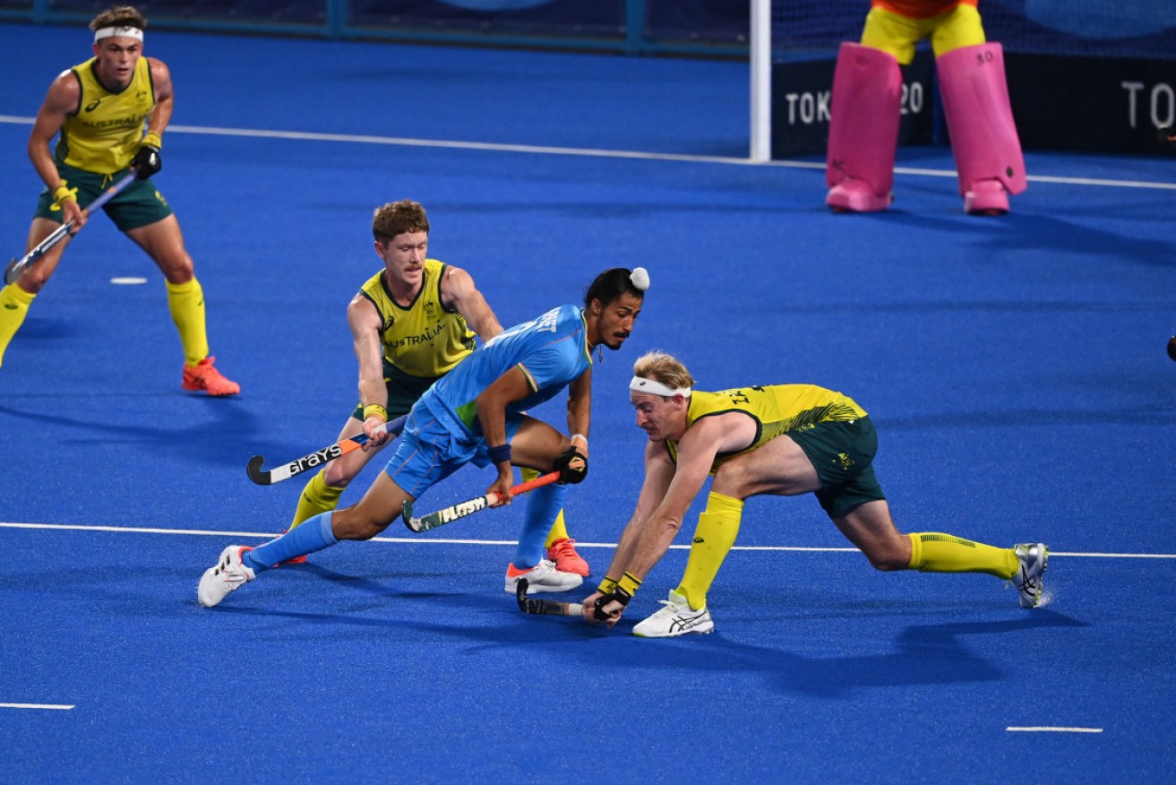 Australia's Matthew Dawson and Aran Zalewski compete with India's Dilpreet Singh on Sunday. 