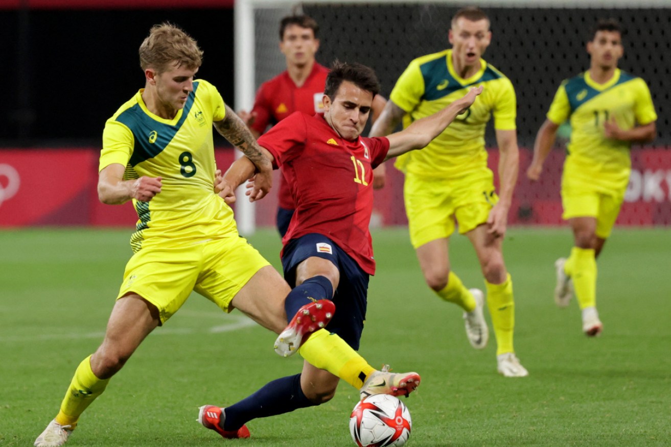 Riley McGree shields the ball from Spain's scorer Mikel Oyarzabal.