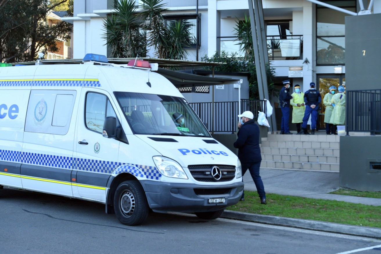 Health workers and police at the Blacktown apartment block on Tuesday morning.