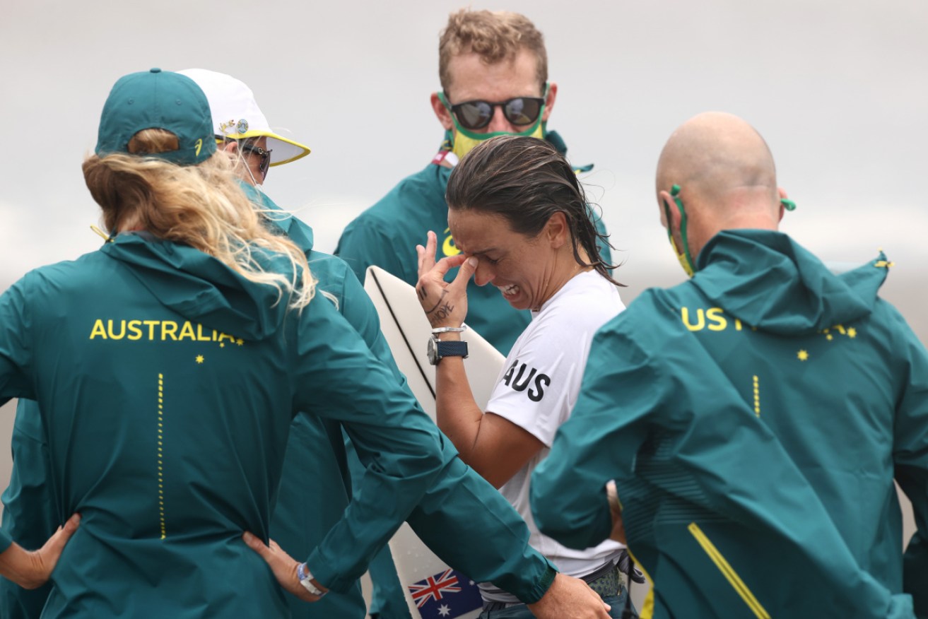 An upset Sally Fitzgibbons is comforted by Australian officials after Tuesday's loss.