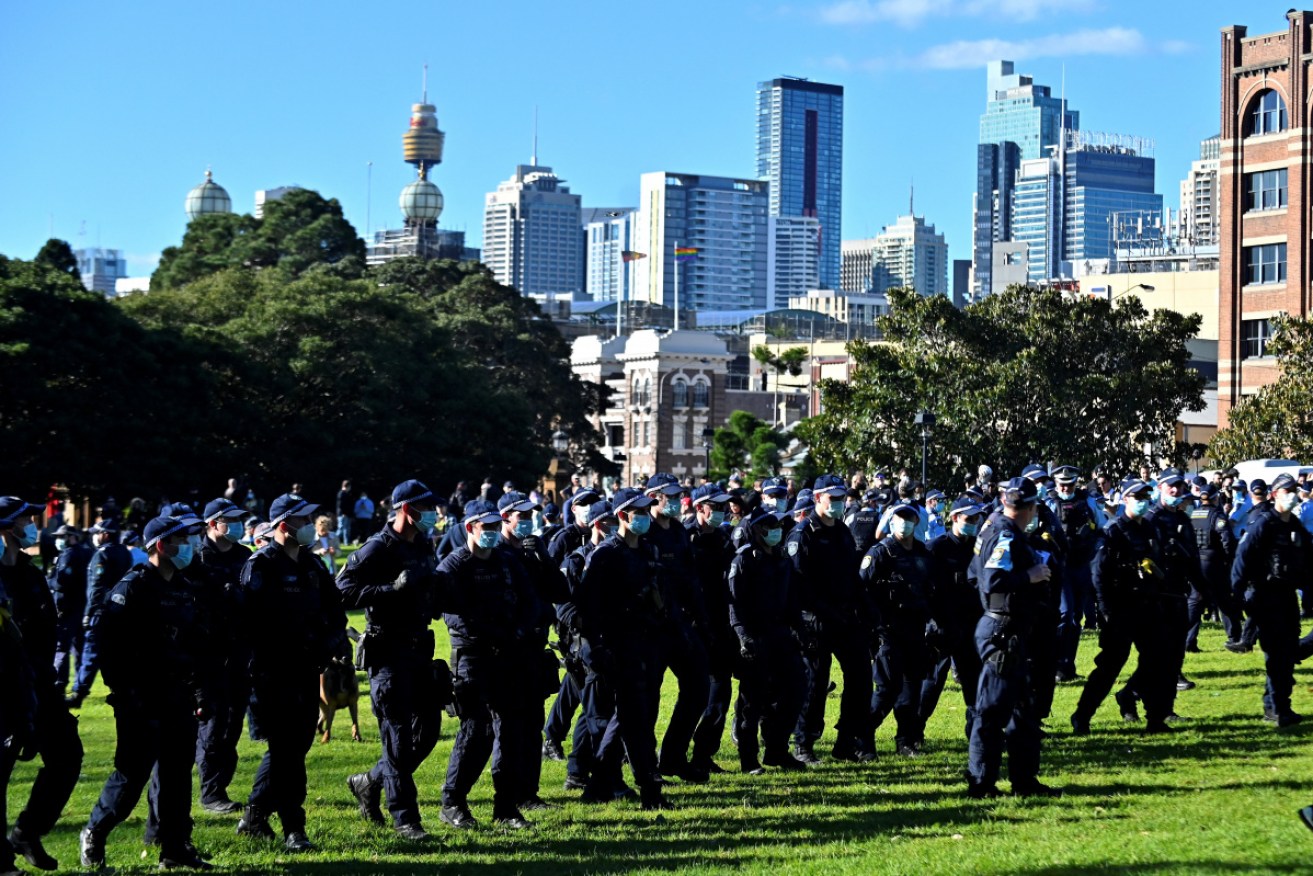 A line of police confronts protesters at last Saturday's anti-lockdown rally.